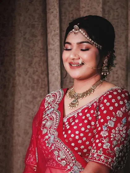 A close-up of the bride's soft glam makeup. The subtle shimmer on the eyelids and the natural flush on her cheeks create a look of effortless beauty.