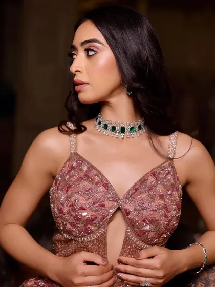 Dazzle in every detail. This is a soft glam cocktail look featuring a beautiful pink embellished gown and an emerald choker, with makeup to match the elegance.