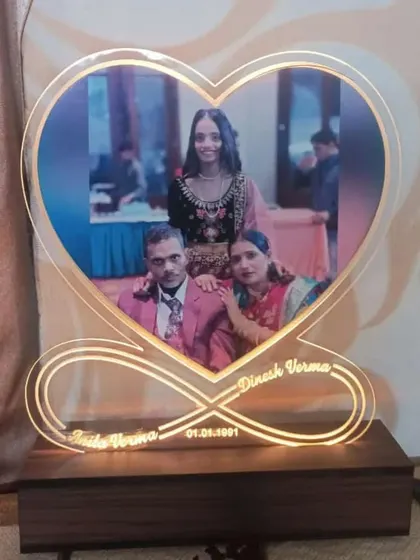 A heart-shaped LED photo frame with an infinity symbol base, personalized with names and a special date.