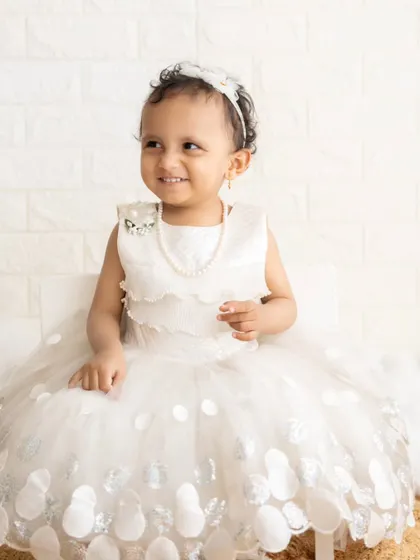 A lovely portrait of a little girl in her white dress, looking like a little angel.