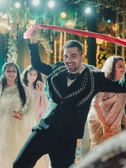 The groom dances with infectious energy on the sangeet dance floor.