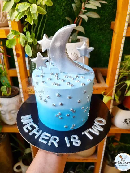 "Twinkle Twinkle Little Star" was the theme for this second birthday cake. The blue ombre, silver moon and stars, and personalized name create a magical night-sky effect.