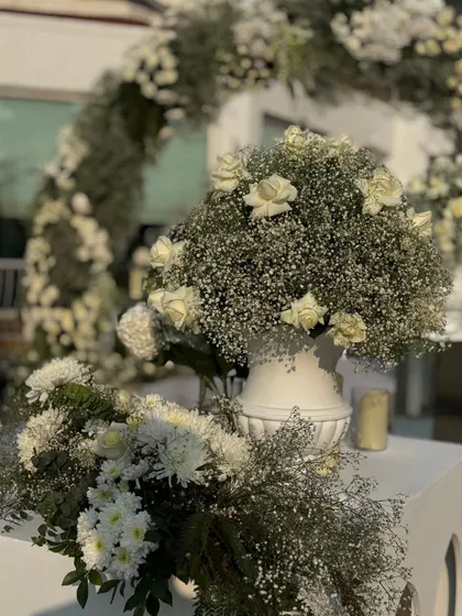 A close-up of the entrance decor, with bountiful arrangements of white roses and baby's breath, creating a soft and romantic welcome.