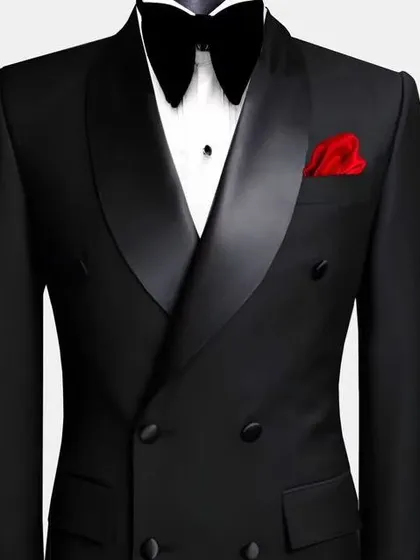 A classic double-breasted black tuxedo with a peak lapel and a pop of color from a red pocket square. This is a powerful and confident look for any formal occasion.