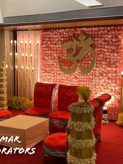Another view of the 'Din Shagna Da' mandap, showing the traditional floral-wrapped pillars and seating arrangement. This design is perfect for creating a classic and auspicious setting within a banquet hall.