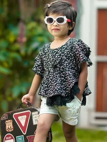Ready for an adventure! This little girl is all set with her vintage suitcase and cool sunglasses for a fun travel-themed outdoor shoot.