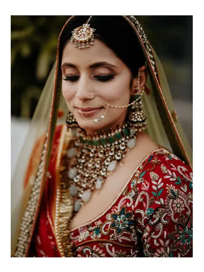 A close-up portrait focusing on emotion. The bride's serene, eyes-closed smile and the intricate details of her jewelry are the heroes of this beautiful, intimate shot.
