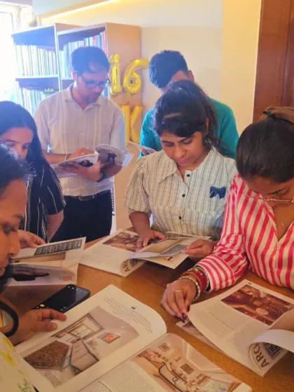 A candid moment of our team gathered together, sharing in the success of a project. This collaborative spirit is at the heart of our studio culture.