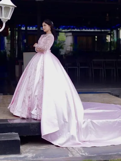 This shot captures the dramatic elegance of the pink gown's long train. It's a perfect choice for a bride who wants a truly memorable entrance.