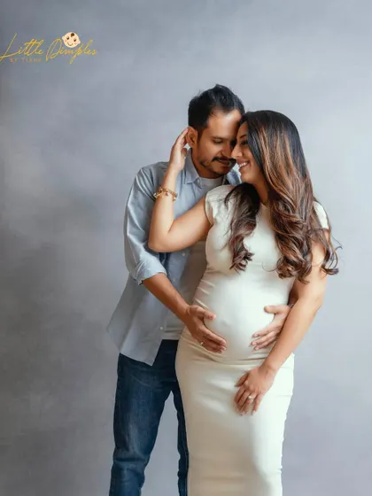 A timeless and classic couple's portrait. The simple outfits and grey backdrop create a modern and sophisticated look that focuses on their connection.