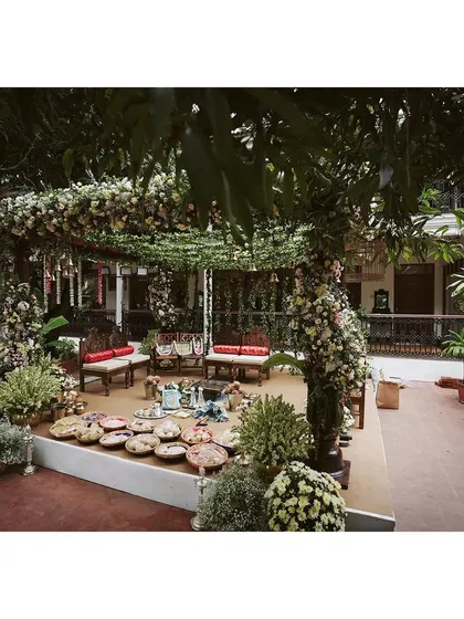 A wider view of the Chettinad-inspired mandap, designed to blend seamlessly with the venue's natural trees and foliage.