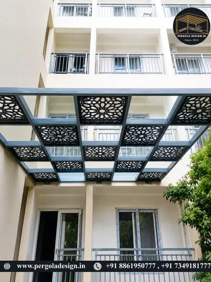 This apartment balcony is enhanced with a glass and CNC-cut panel pergola. The design adds a layer of sophistication and privacy, transforming a simple balcony into a more luxurious outdoor space.