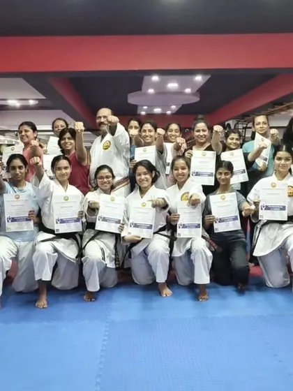 A group of empowered participants proudly holding their certificates after completing a women's self-defense workshop at my Honbu Dojo. This moment represents not just new skills learned, but a significant boost in confidence.