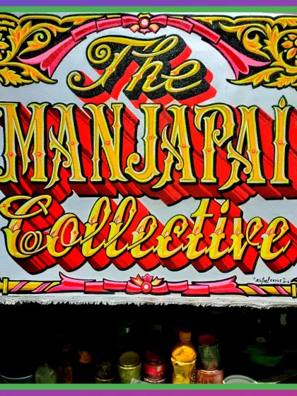 The completed sign for 'The Manjappai Collective', now with a fully detailed, traditional floral border. This is a great example of a custom business sign.