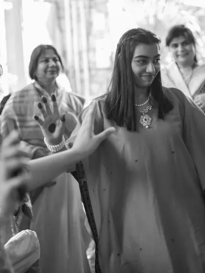 A black and white shot of our co-founder wearing the upcycled kaftan, a timeless piece created from her mother's memories.