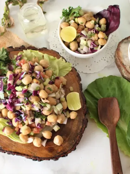 A closer look at our fresh chickpea salad, beautifully presented on a wooden platter. Packed with protein, fiber, and fresh vegetables, this is a key component in many of our meal plans, especially for those managing their blood sugar.