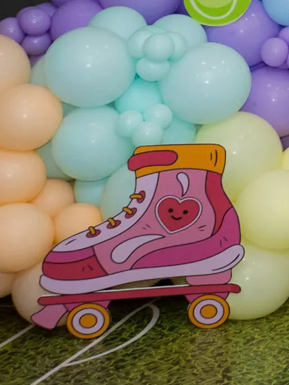 It's all in the details. This cute roller skate cutout was part of a larger, vibrant sports-themed party, adding a touch of personalized fun.