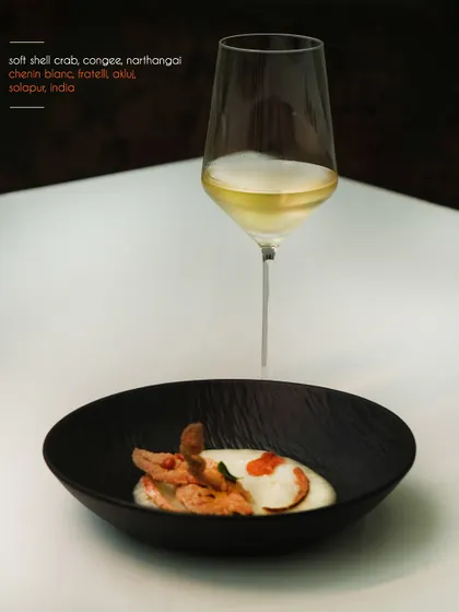 This dish of soft shell crab with congee and narthangai is paired with a Chenin Blanc from Fratelli wines. The pairing highlights the delicate sweetness of the crab.