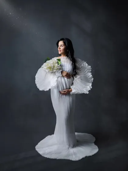 Looking towards the future with hope and joy. This artistic maternity portrait uses light and shadow to create a truly memorable image.