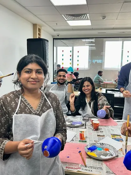 A candid shot of the team enjoying the pot painting process. It’s a great way to encourage conversation and connection in a low-pressure environment.