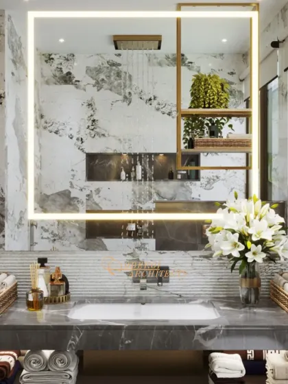 A close-up of the backlit mirror, which features an integrated gold-accented shelf, reflecting the rain shower and creating a sense of depth.