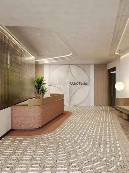 The entrance lobby we designed for the 'Sanctum' apartments sets a tone of sophisticated calm. The design features a curved reception desk, a long built-in bench, and a unique patterned floor, all rendered in a soft, neutral palette with warm lighting.