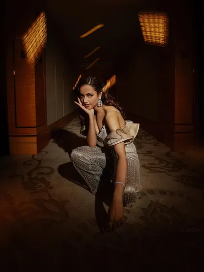 The play of light and shadow in this shot of Shanvi Srivastava adds drama to the sequined jumpsuit. The composition highlights both the outfit and her confident pose.