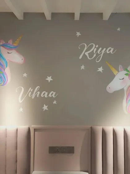 A close-up of the unicorn mural we painted for Riya and Vihaa's room, showing the soft pastel colors and starry details.