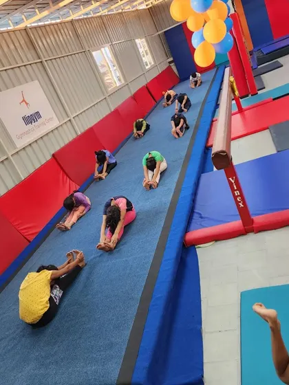 The gym was decorated with balloons for our first anniversary, but the real celebration was seeing our students stretching and training together.
