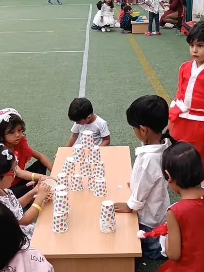 A Christmas carnival game of stacking cups. These festive activities are designed to be fun while also developing concentration and fine motor skills.