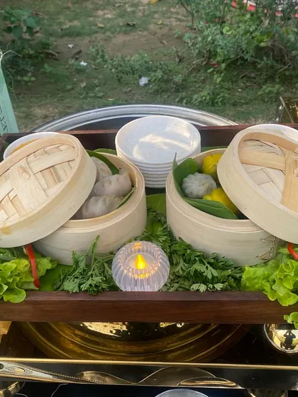 Freshly steamed dim sums served in traditional bamboo baskets. This simple yet elegant presentation is part of our live dim sum station, offering guests an authentic and delicious experience.