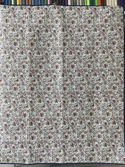 The backing fabric for the classic Lone Star quilt, a simple paisley print that complements the front.