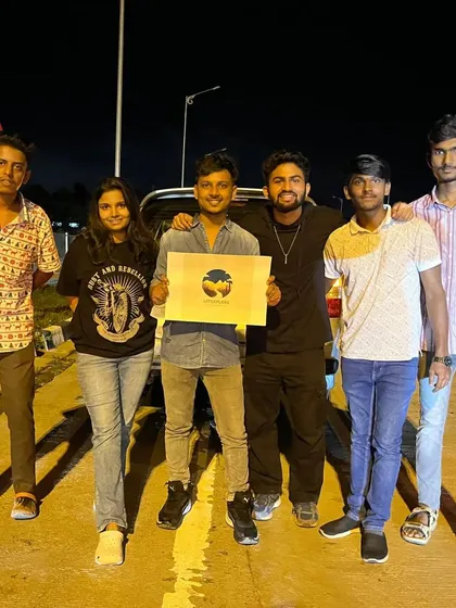 A duplicate of the group holding the 'Let's Explore' logo at the start of our Ooty trip. We are a community of explorers.