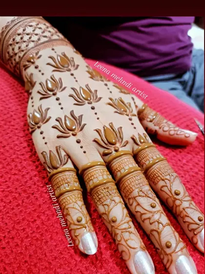 A beautiful lotus design on the back of the hand. This shows the final result on skin, with bold, clean lines and delicate dot work, a style we practice extensively.
