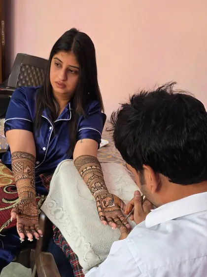 Here I am, focused on applying a detailed bridal mehandi. It takes hours of patience and concentration to ensure every line is perfect for the bride's special day.