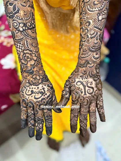 A detailed shot of the palms for the 'YS' mehendi, showing the beautiful calligraphy and initial work.