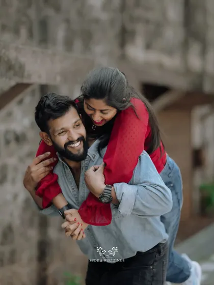 A joyful piggyback moment, the couple's laughter making this a heartwarming and candid shot.