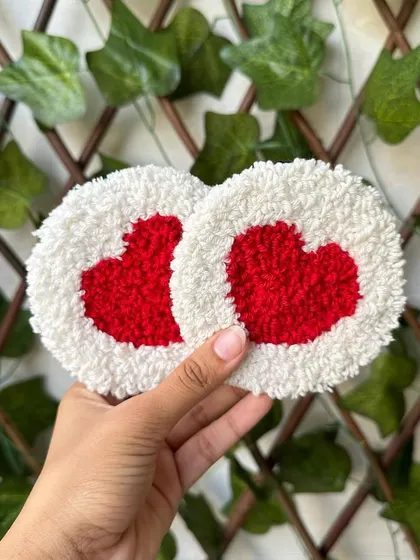 A pair of our punch needle heart coasters in a classic red and white design. These are perfect for Valentine's Day or for adding a touch of love to your decor year-round.