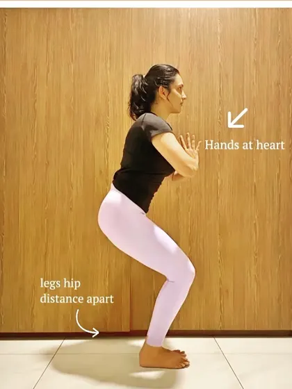 If holding your arms up in Chair Pose feels like too much, this modification with hands at the heart is a great option. It allows you to focus on strengthening your legs and core without straining your shoulders.