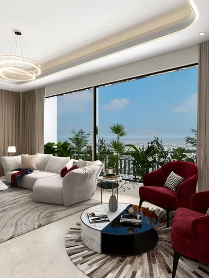 A wider view of the living space, showing how two bold red armchairs serve as a focal point. They are positioned to enjoy the panoramic view while anchoring the seating area, which also includes our large, curved sectional sofa.