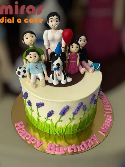 A cake celebrating a Nani's birthday, topped with a figurine of the whole family, including the dog. It's a beautiful representation of family love, decorated with lavender flowers.