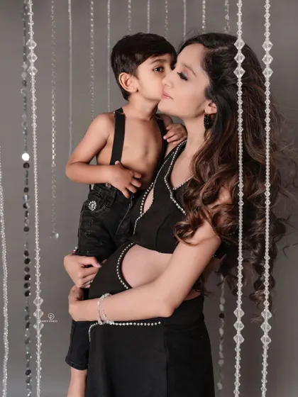 A mother's love, ready to be shared. This beautiful shot of a mom and her son captures the special bond they have as they await the arrival of a new baby.