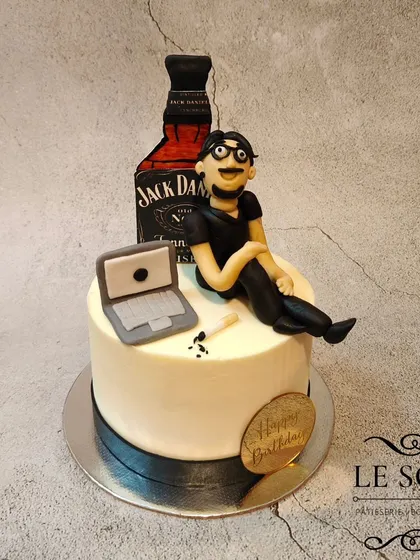 This "Vices" cake was for a quarter-life crisis celebration. The half-kg cake features a 3D fondant figurine chilling with his laptop and a Jack Daniel's bottle.