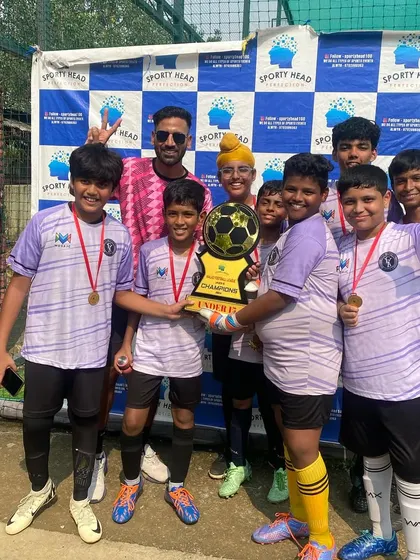 Our Under-15 team celebrating their championship win at the Sportyhead Premier League. We provide platforms for our youth teams to compete, learn, and experience the joy of lifting a trophy together.