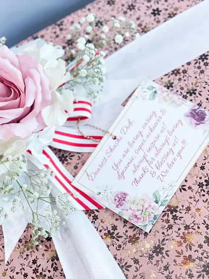 The finishing touch on a custom bride box: a personalized note card and a beautiful floral arrangement. It's these little details that make a gift truly special.