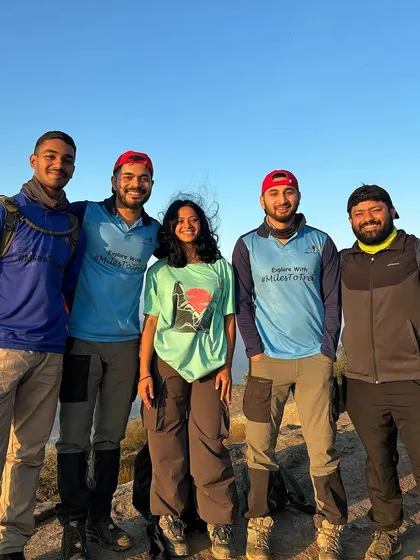 Our trek leaders posing with a participant at sunrise. We build a friendly rapport with our groups, making the experience more personal and enjoyable.