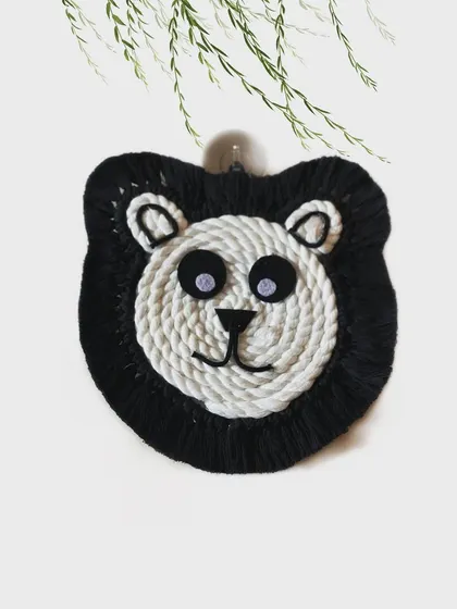 A sweet panda face wall hanging. The contrast of the black and white cord creates this instantly recognizable and beloved animal.