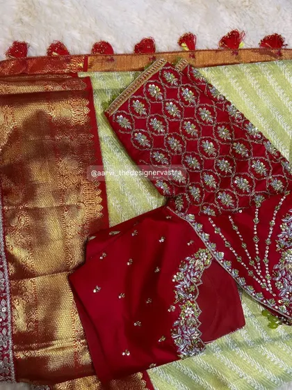 The full set of the red bridal blouse with its matching saree, showing how the embroidery complements the entire outfit.
