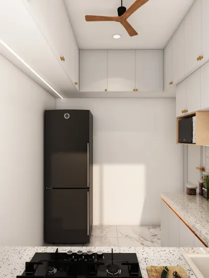 A minimalist kitchen with all-white cabinets, a terrazzo countertop, and a black refrigerator that creates a bold contrast.