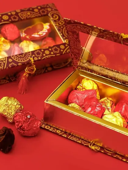 Our Assorted Chocolate Rocks in a luxurious red and gold gift box. The packaging is designed to reflect the festive spirit of Diwali, making it a premium gift choice.